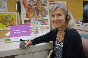 Audiologist Marilyn Reed hold an amplification device in her office