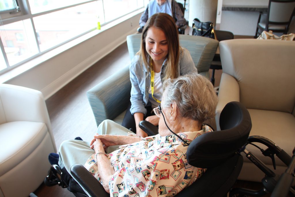 PLEASE volunteer Sabrina Teles interacts with a resident.