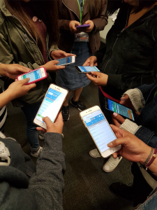 Six people are pictured engaging with the SOS app.