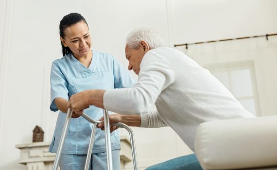 oyful nice woman helping an elderly man
