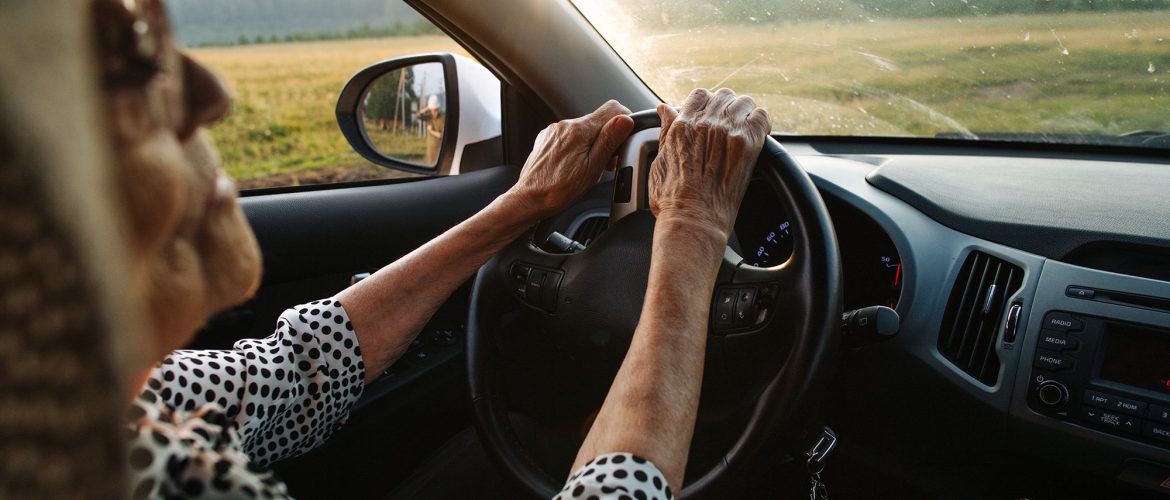 Older woman with sun glasses driving.