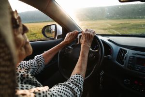 Older woman with sun glasses driving.