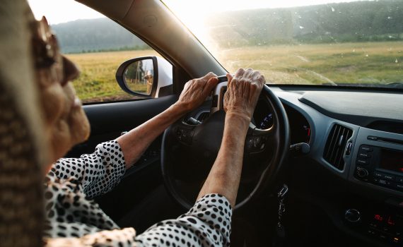 Older woman with sun glasses driving.