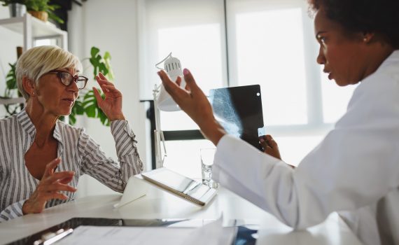 Doctor looking over lab results with female patient