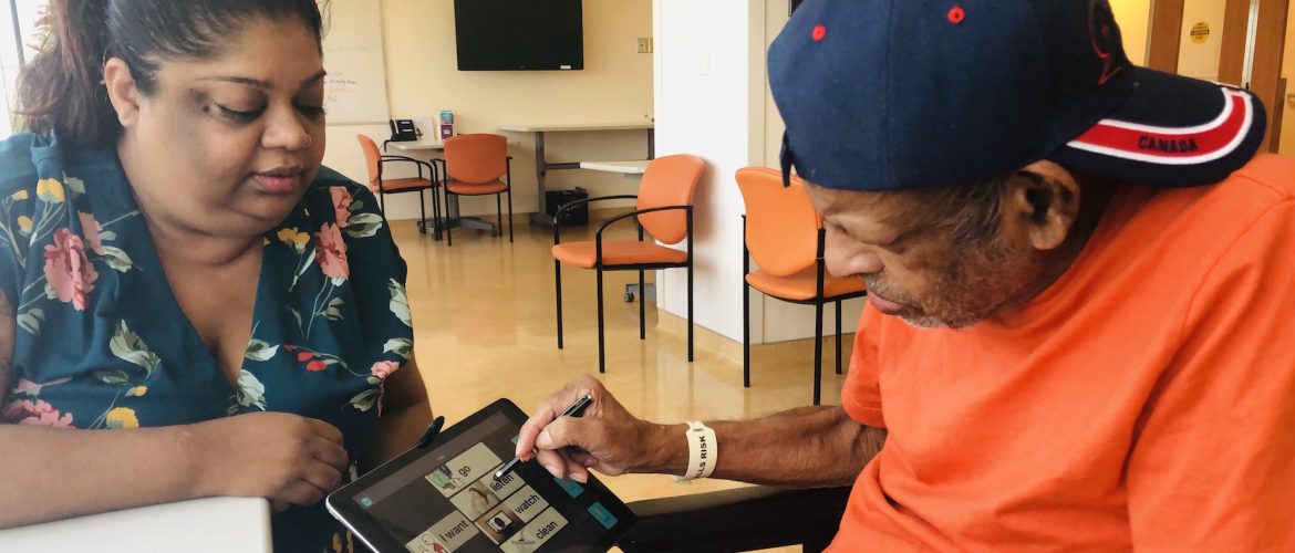 A woman and a man using a tablet together.