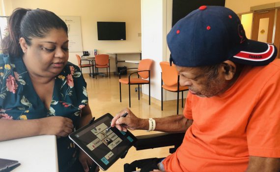 A woman and a man using a tablet together.