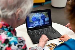 Older adults looking over health information at a laptop