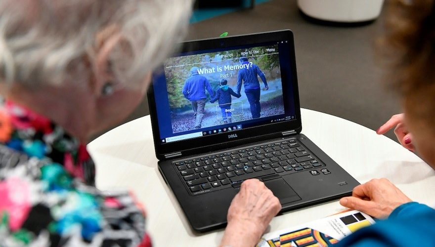 Older adults looking over health information at a laptop