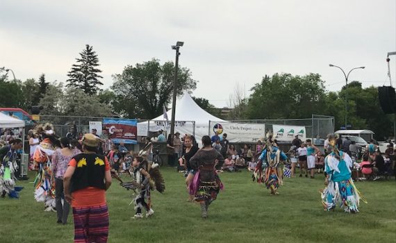 Indigenous Pow Wow on a green Field.