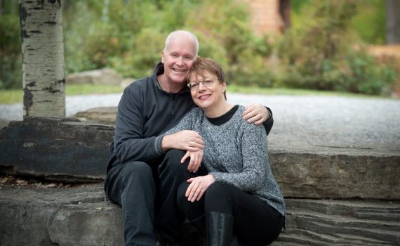 John and Cindy McCaffery sit together out in a nature setting