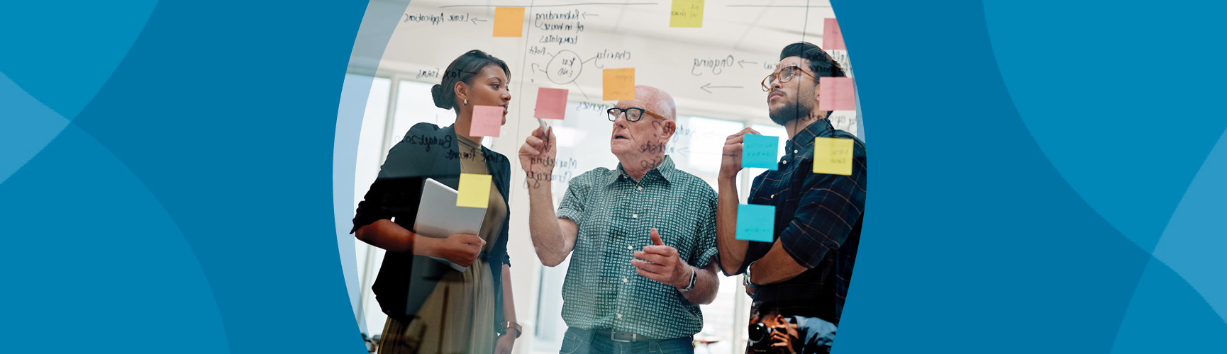 Older adult man brainstorming with innovation team of young man and woman