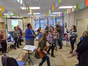 People singing and dancing in a room.