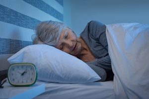 Woman sleeping in a bed.