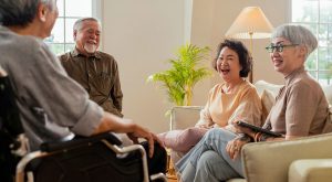 A group of older adults are gathered together laughing.