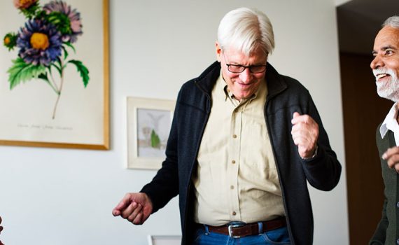 A group of older adults are dancing.