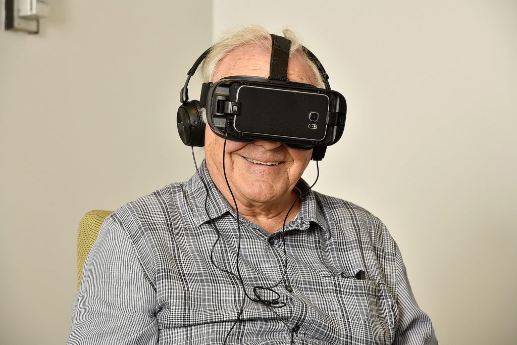Senior man wearing virtual reality headset while sitting in a chair