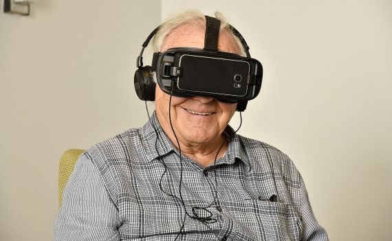 Senior man wearing virtual reality headset while sitting in a chair
