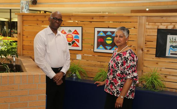 The project lead Renee Climans is standing next to artwork