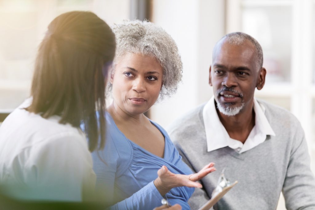 Senior woman talking with a female point-of-care worker about care