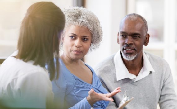 Senior woman talking with a female point-of-care worker about care