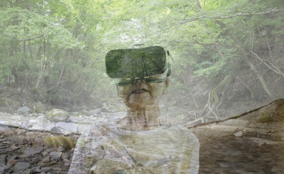 Senior woman wearing a virtual reality headset and viewing mountain stream in a virtual reality world
