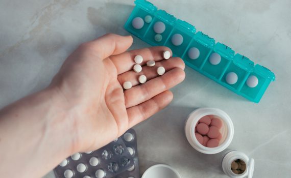 A handful of medication and medication boxes