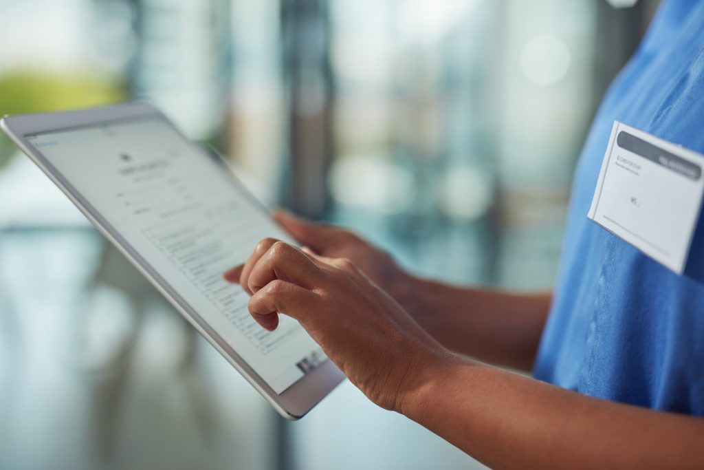 Clinician uses a digital tablet in a hospital