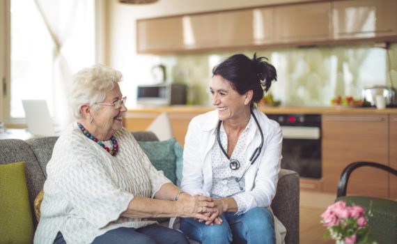 Nurse care coordinator speaking to older adult patient