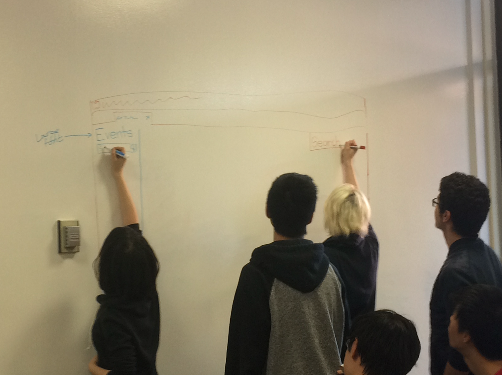 Students draw on the white board during a CABHI-hosted workshop to brainstorm innovations.