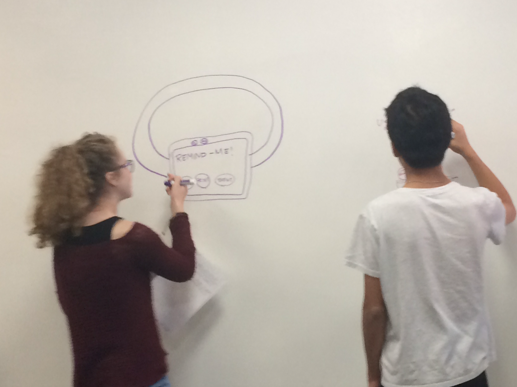 Students draw on the white board during a CABHI-hosted workshop to brainstorm innovations.