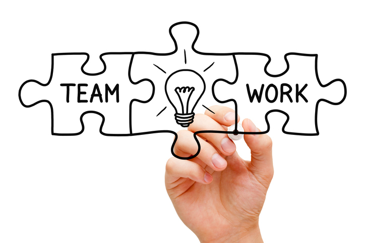 Hand sketching teamwork puzzle