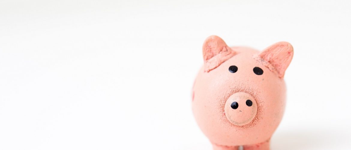 A pink piggy bank set against a white backdrop.