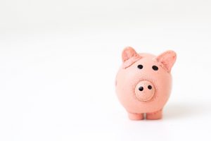 A pink piggy bank set against a white backdrop.
