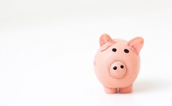A pink piggy bank set against a white backdrop.