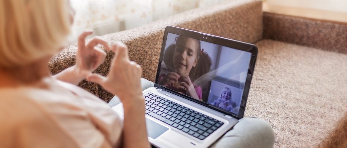 Older adult woman on a video conference call with a little girl.