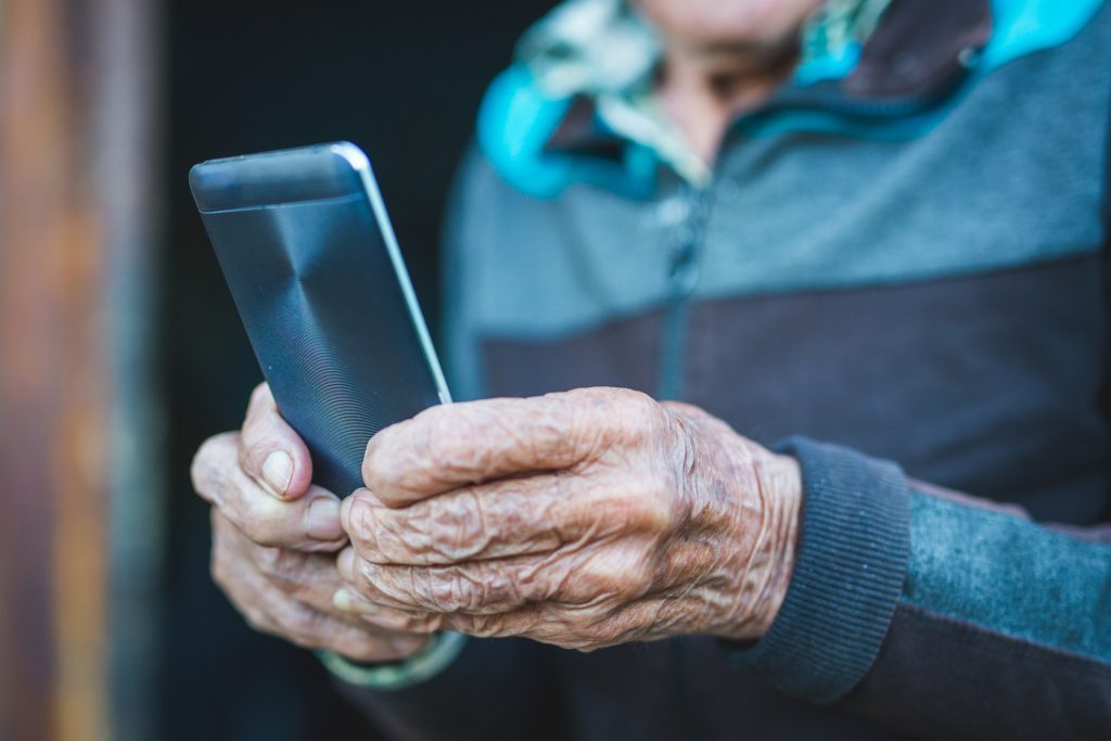 Older adult holds smartphone