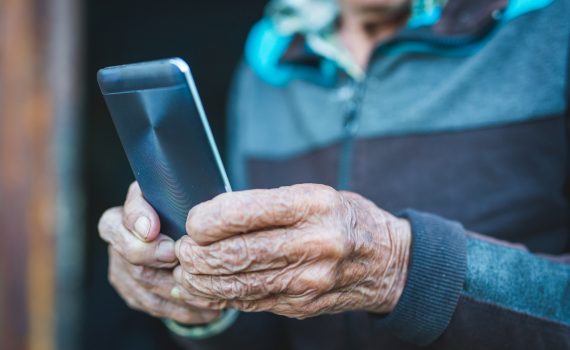 Older adult holds smartphone