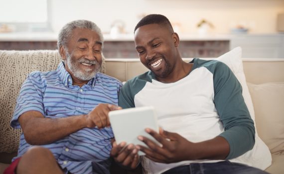 Two men using a tablet
