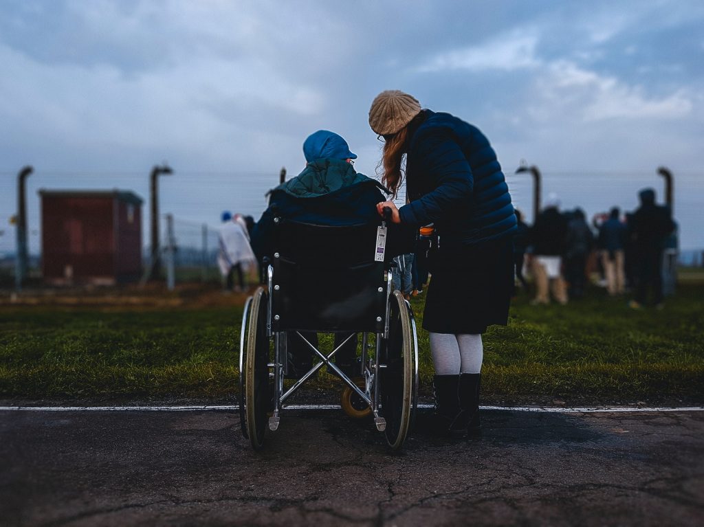 Person in a wheelchair beside a person standing
