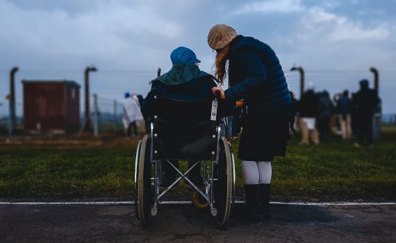 Person in a wheelchair beside a person standing