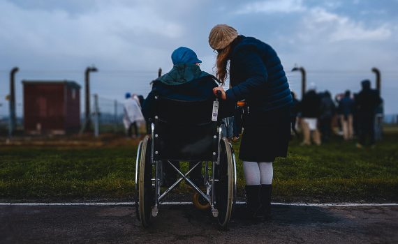 Person in a wheelchair beside a person standing