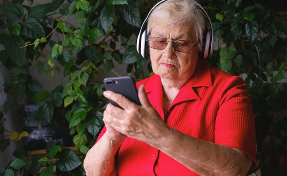 Senior woman listening to music on her phone