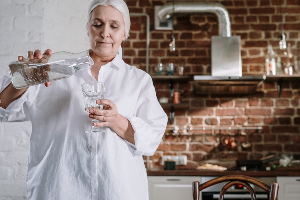 Woman pouring water into a glass