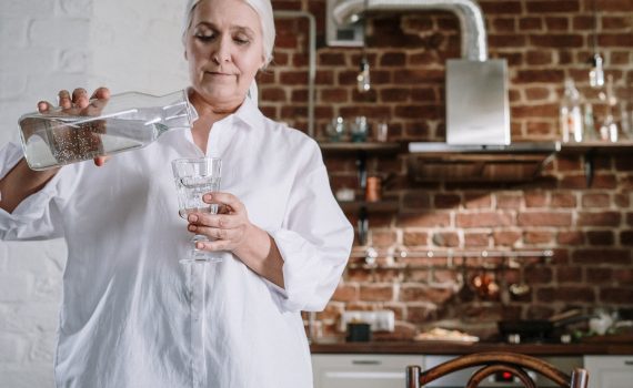 Woman pouring water into a glass