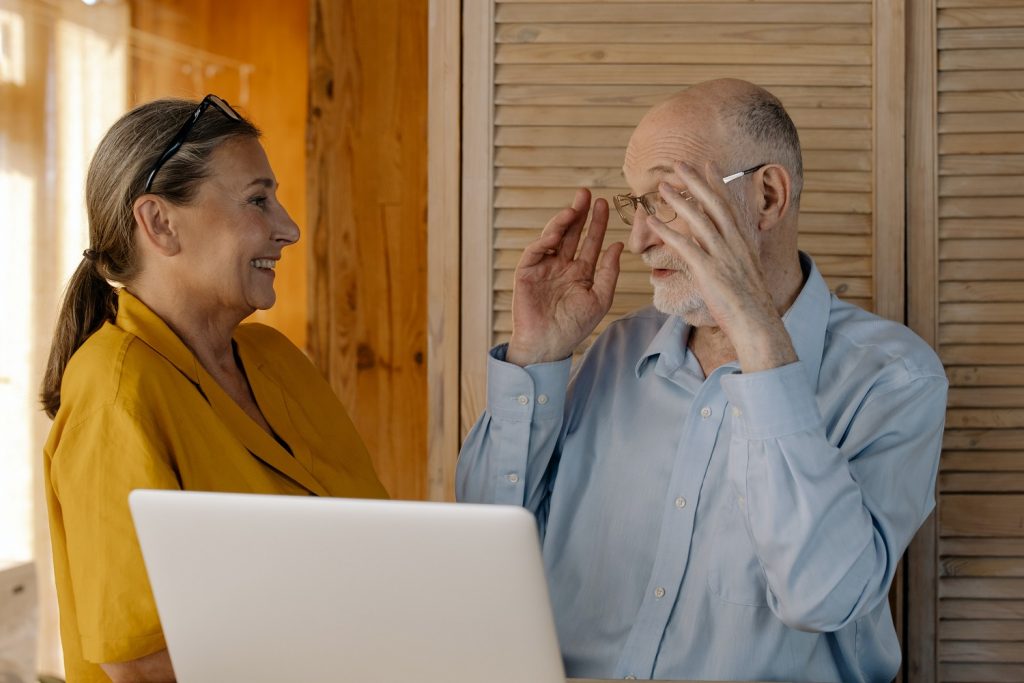 Older adult man and woman laughing together