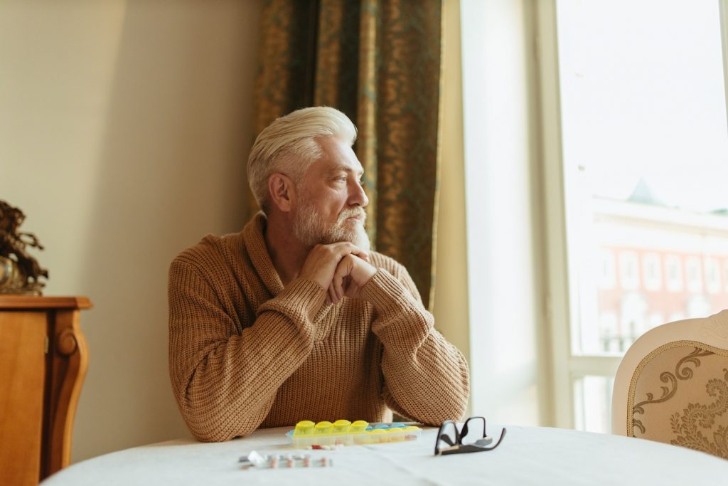 Older adult man staring into the distance