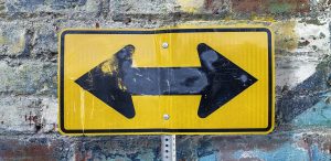 Road sign with arrows pointing in multiple directions