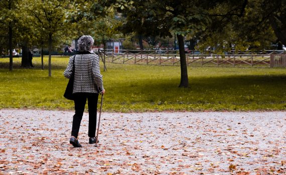 Woman walking in the park with a walker